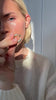 video of woman adding jewelry pieces to her ears and fingers